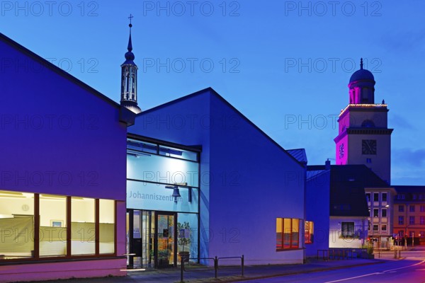 The Johanniszentrum with the top of St. John's Church and the Town Hall Tower in the evening, Witten, Ruhr area, Germany