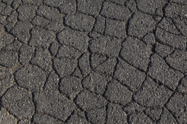 Top view and close-up of cracked asphalt road surface, Quebec, Canada