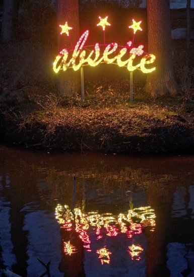 The river Lippe at the Marineverein with the artwork by Jan Philip Scheibe at night, Lichtpromenade Lippstadt, North Rhine-Westphalia, Germany
