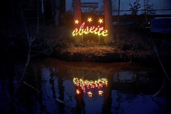 The river Lippe at the Marineverein with the artwork by Jan Philip Scheibe at night, Lichtpromenade Lippstadt, North Rhine-Westphalia, Germany