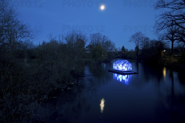 The river Lippe with the artwork Arche by Christoph Hildebrand at night with full moon, Lippstadt light promenade, North Rhine-Westphalia, Germany