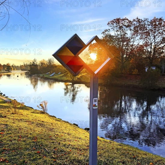 Sunrise over the Lippe river with the sign of the discovery route Wasser Wege Winkel, Lippeaue, Lippstadt, North Rhine-Westphalia, Germany