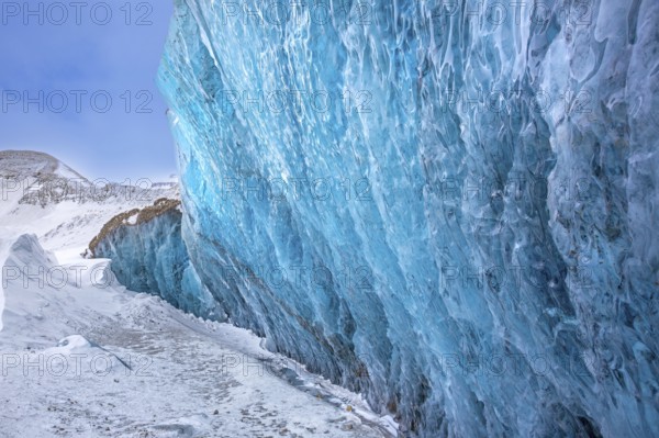 Glacier wall showing smooth melting blue ice made of compressed snow, Spitsbergen / Svalbard, Norway