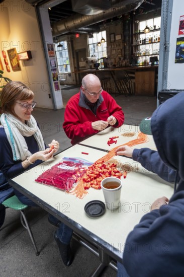 Detroit, Michigan - Volunteers with the Detroit Peoples Assembly put together whistle kits. The whistles are designed to alert others in the community when immigration agents are nearby