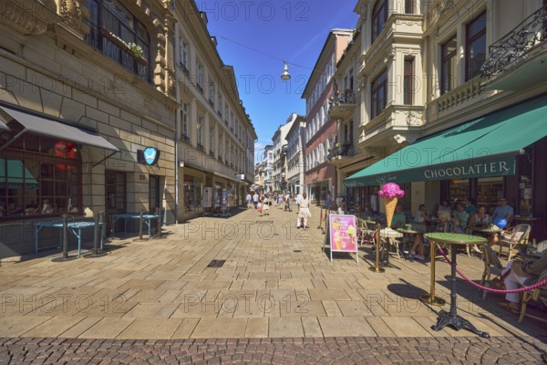 Pedestrian zone, general architecture, residential and commercial buildings, shops, shopping, retail, outdoor area of a restaurant, ice cream parlour, Maison Köller - L'Art Sucré, shop and café, paving and concrete paving stone walkway, pedestrians as accessories, blue sky, cloudless, market street, Wiesbaden, state capital, district-free city, Hesse, Germany