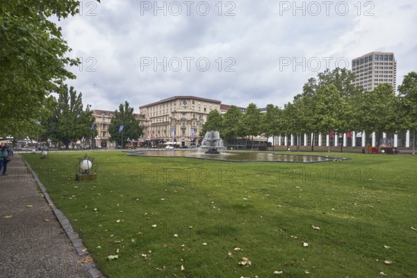 Green spaces, lantern, lawn, paths, trees, Platanus × acerifolia (Platanus ×hispanica), fountain, general architecture, high-rise building, cloudy, nimbostratus clouds, bowling green, Kurhausplatz, Wiesbaden, state capital, independent city, Hesse, Germany