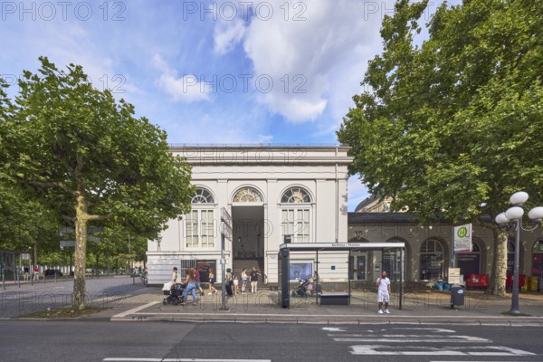 Spa hotel Theater bus stop, bus shelters, people waiting for means of transport, road marking BUS, historic building, theatre, trees, lantern, blue sky, cumulus clouds, Wilhelmstraße, Wiesbaden, state capital, district-free city, Hesse, Germany