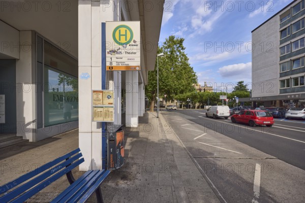 Spa hotel Theater bus stop, public transport, bench, zigzag line road marking, vehicles, general architecture, commercial building, lantern, trees, blue sky, cumulus clouds, Burgstraße street, Wiesbaden, state capital, district-free city, Hesse, Germany