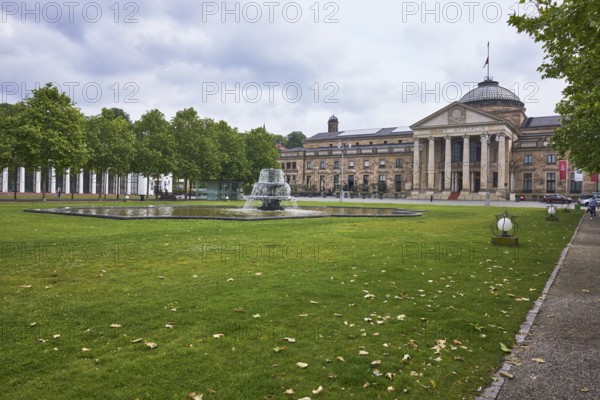 New spa hotel, casino, green areas, trees, Platanus × acerifolia (Platanus ×hispanica), lantern, lawn, paths, bowling green, fountain, cloudy, nimbostratus clouds, Kurhausplatz, Wiesbaden, state capital, independent city, Hesse, Germany