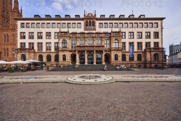 New Town Hall, Historic Building, Neo-Renaissance Style, Architect Georg von Hauberrisser, Entrance Area, Staircase, Facade with Windows, Paving Stone Square, Imperial Eagle of the German Empire Mosaic, Pedestrians as Accessories, Seated People, Blue Sky, Cumulus Clouds, Palace Square, Wiesbaden, State Capital, Independent City, Hesse, Germany