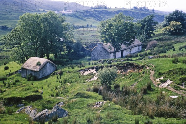 Thatched stone blackhouse traditional croft farmhouse building, Portnoo, County Donegal, Ireland 1969