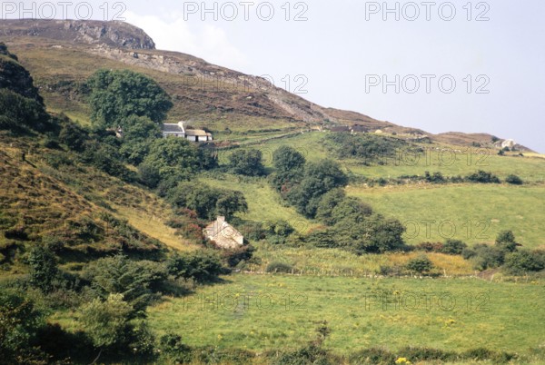 Traditional crofting farming landscape, croft farmhouses in small fields on hillside, County Donegal, Ireland 1971