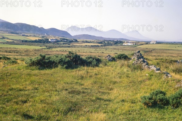 Traditional crofting farming landscape, croft farmhouses in small fields, distant mountains, County Donegal, Ireland 1971