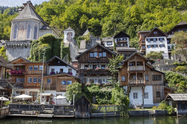 A, Hallstatt, central European village with old wooden houses on the water, surrounded by nature, Austria
