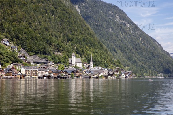 A, Hallstatt, An idyllic lakeside village with a church, surrounded by wooded mountains, Austria