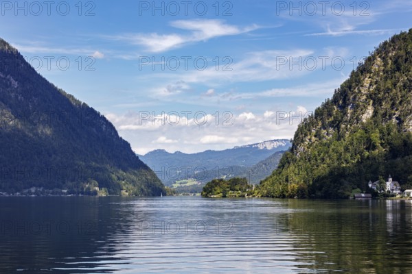 A, Hallstatt, A quiet lake with mountain scenery under a blue sky with cloud formations, Austria