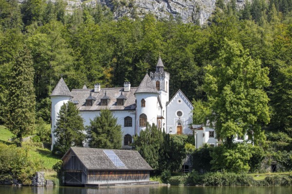 A, Hallstatt, An idyllic lakeside castle surrounded by a thick green forest, Austria