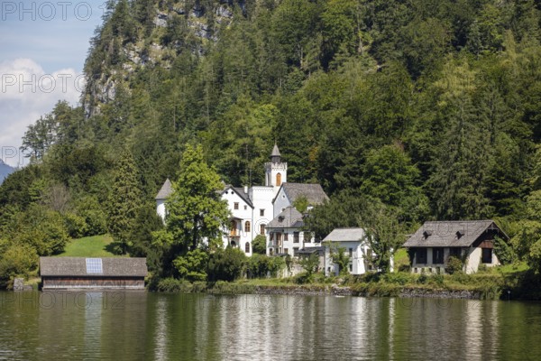 A, Hallstatt, An estate with several buildings on the shores of a lake, surrounded by trees, Austria