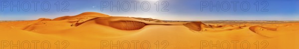 Panoramic view of vast orange sand dunes under bright skies, Sahara, Morocco