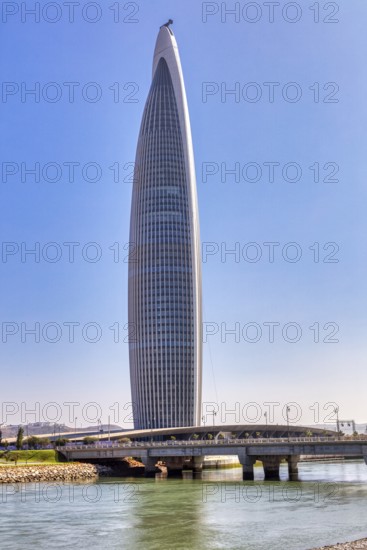 Modern skyscraper on a river with a bridge under clear sky, Mohammed VI Tower in Rabat in Morocco