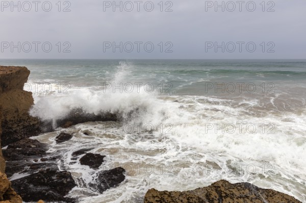 Powerful waves crash against rocks