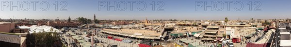 Panoramic view of a lively Moroccan city with markets and traditional buildings
