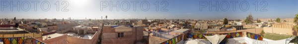 Panoramic view of a Moroccan city with traditional roofs and clear skies