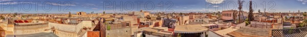 Panoramic view of the rooftops of Marrakech in Morocco under a blue sky with some clouds