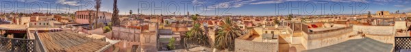 Panoramic view over rooftops of a historic city with blue skies