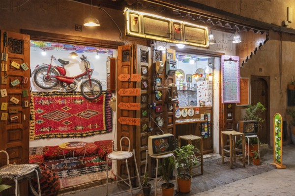 Colourful cafe with decoration and lights, a wheel hanging on the wall