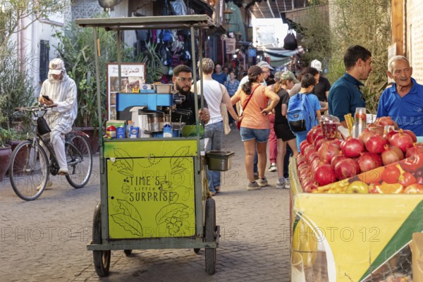 Street stand with fruit and a vendor on a busy street