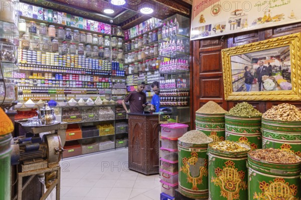 A shop with a variety of spices and products on shelves, traditionally furnished