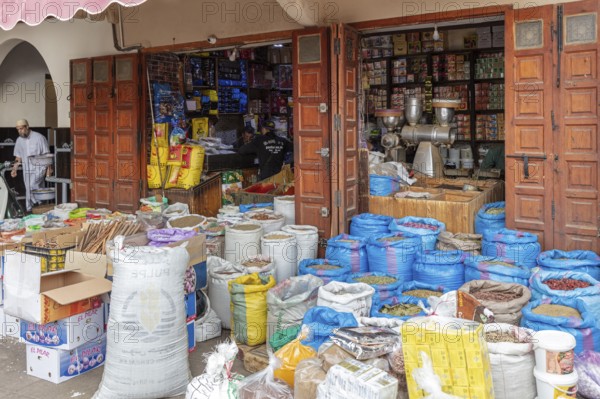 Open shop full of bags and products, traditional product presentation with wooden doors