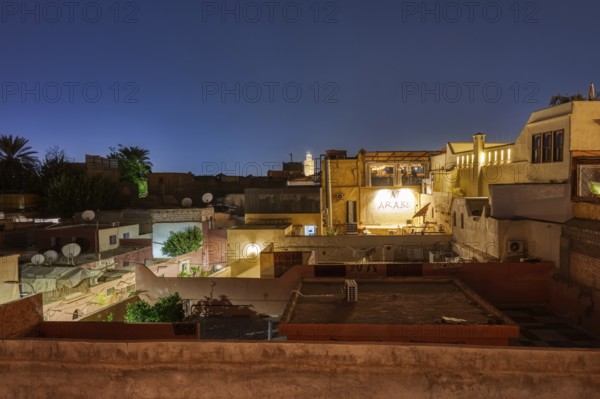 View of an urban landscape at night from a roof terrace
