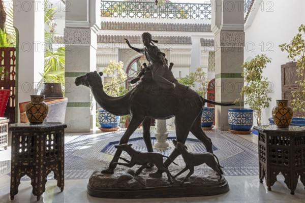 Decorative camel statue with rider in an area with ornate tiles