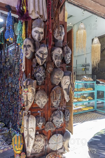 Traditional African decoration with wooden masks and pearls in a shop