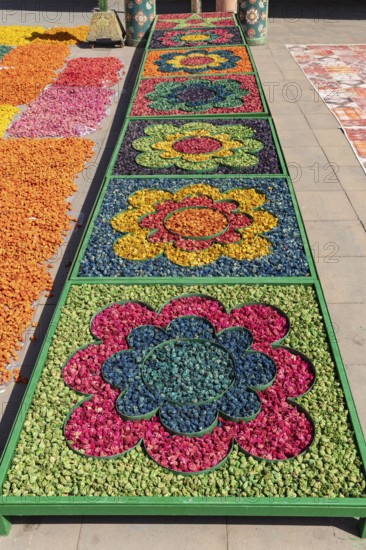 Colourful floral arrangements in geometric patterns at a market