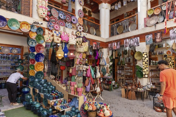 Lively market stall full of colorful pottery and traditional crafts