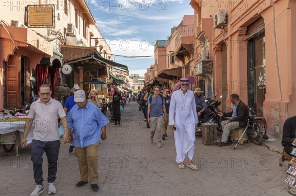 Busy street with people strolling between culturally influenced buildings