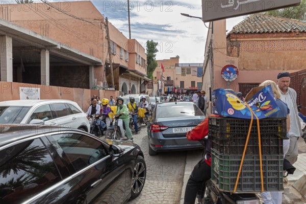 Bustling street full of people and vehicles in an urban setting