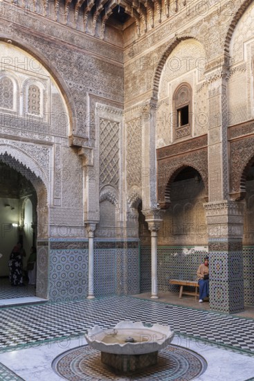 Detailed courtyard with geometric mosaics and round arches, quiet atmosphere