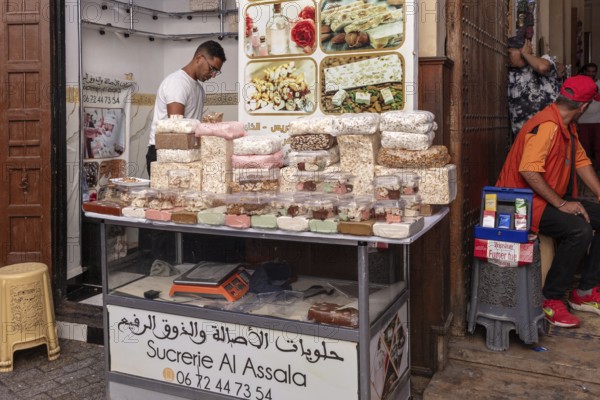 A stall full of colorful oriental sweets at a market