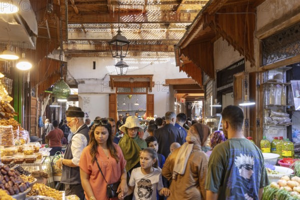 Hustle and bustle in a covered bazaar full of people and stalls