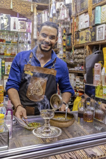 Friendly seller offers products in a busy bazaar