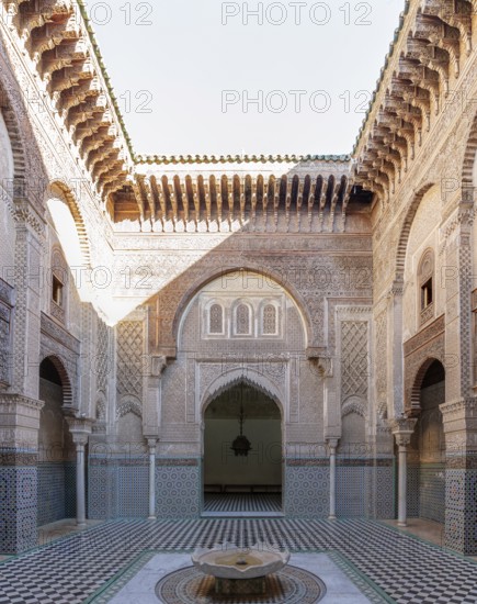 A magnificent courtyard with ornate decorations and a central fountain