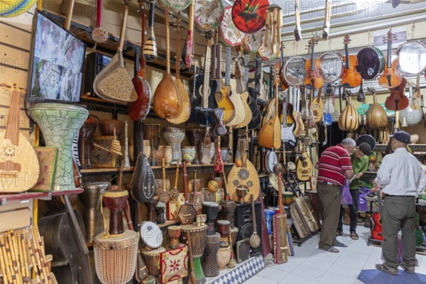 Interior view of a music store with many traditional instruments and customers