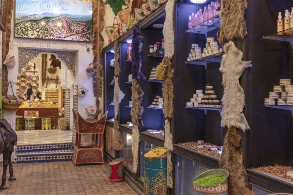 A traditional market with lots of products on shelves, illuminated by warm light and decorated with colorful elements