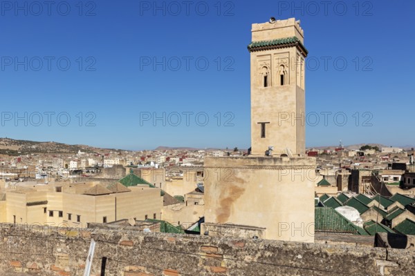 View of a city with a distinctive tower and blue sky