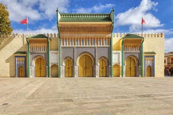 Detailed view of an ornate palace entrance with colorful mosaics and arches