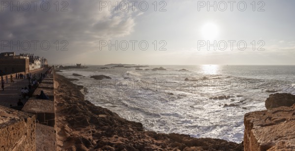 Coastal landscape at sunset with dramatic sky and waves